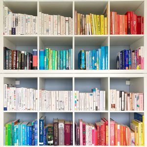 a picture of a book case with books sorted by color that i want to talk about on my book blog