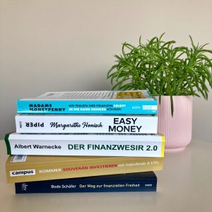 the best books on personal finance in german stacked upon each other